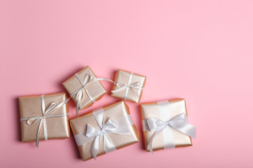 Gifts in gold packaging on a colored background with place for text top view. birthday, christmas, new year, mother's day, march 8, valentines day