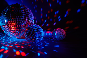 Microphone and  glittering mirror disco balls. Karaoke club. For advertising or web design....