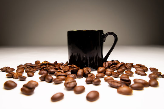 Black coffee mugs and coffee beans