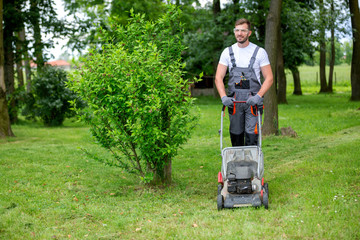 Handsome man dressed in lawn mowing outfit