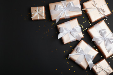 Gifts in gold packaging on a colored background with place for text top view. birthday, christmas, new year, mother's day, march 8, valentines day