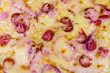 Background of the pizza with sausages, ham and parmesan cheese