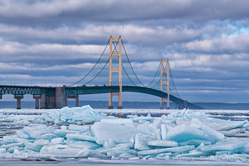Winter landscape of blue ice shards and the Mackinac Bridge, Straits of Mackinac, Lake Michigan,...