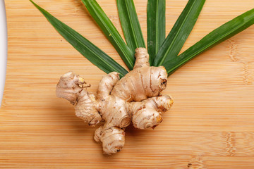 Ginger with green leaf  over white background 