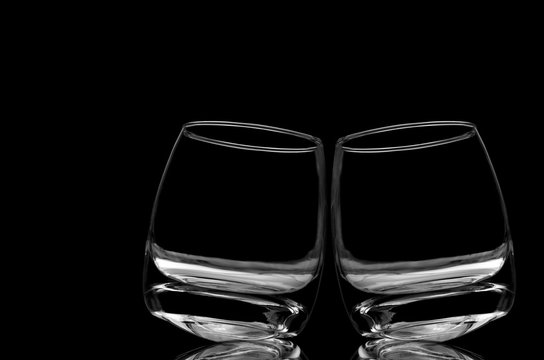 Two Empty Whisky Glasses On A Black Background