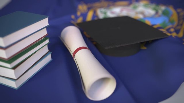 Graduation cap, books and diploma on the flag of New Hampshire. Higher education in the USA related conceptual 3D animation