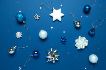 Christmas background with decorations and gift boxes on dark blue background