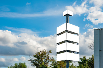 Many advertising banners/billboards on the pole in front of company headquarters