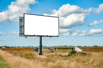 Blank white billboard for advertisement near the highway - obrazy, fototapety, plakaty