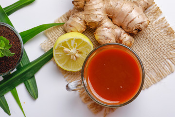 Black tea with lemon and ginger over white background 