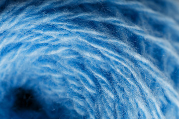 Wool yarn close-up colorful blue threads for needlework in macro.
