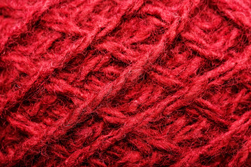 Wool yarn close-up colorful red thread for needlework in macro.