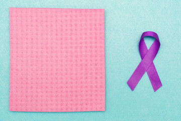 A purple ribbon in support of World Cancer Day, raising the awareness of people living with a pancreatic tumor.