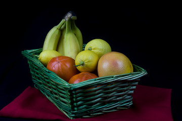 wicker basket with fruits in background with elegant cloth