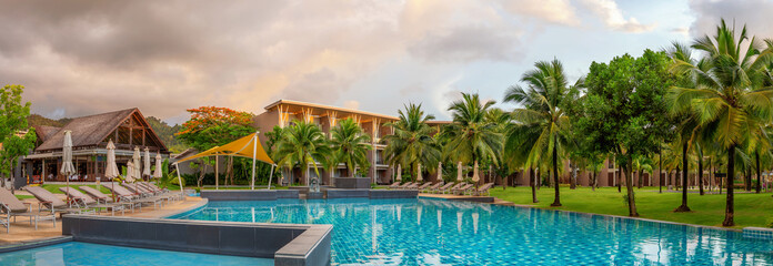 Panorama of the chic five star hotel with pool the sands of katathani. Evening order, palm trees...