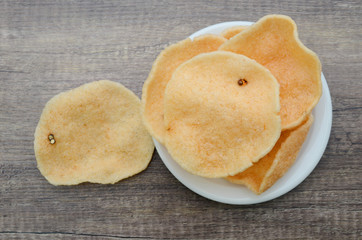 A prawn crackers on white plate