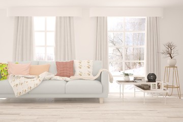 Stylish room in white color with sofa and winter landscape in window. Scandinavian interior design. 3D illustration