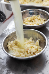 Italian hard cheese silano or caciocavallo in cheesemaker hands. The home-made cheese maker produces handmade caciocavallo. Concept: tradition, italy, mozzarella.The process of making mozzarella.