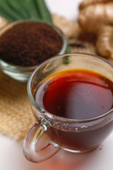 Black tea with lemon and ginger over white background 