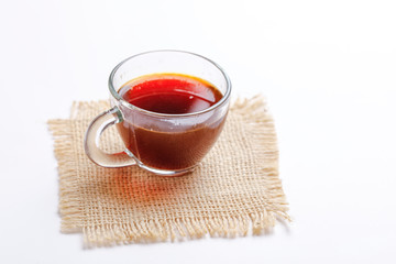 Black tea with lemon and ginger over white background 