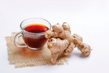 Black tea with lemon and ginger over white background 