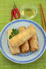 several spring rolls in a dish