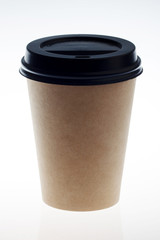 Disposable cup of coffee isolated on white background. Brown paper cup with black lid 