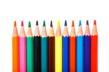 Colored pencils in a row on a white background, free space for text.