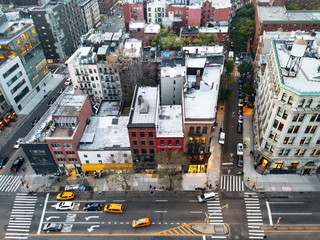 Overhead view of New York City street scene with taxis driving down Bowery past the buildings of the Nolita neighborhood in Manhattan