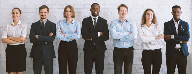 Diverse millennial business team with crossed hands