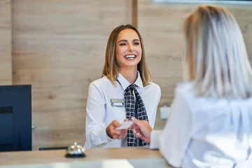 Fotobehang Receptionist and businesswoman at hotel front desk © Kalim