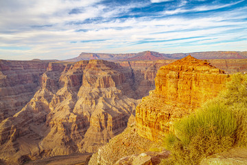 Looking into the Grand Canyon with evening light casting shadows on the layers of rock on the canyon walls.