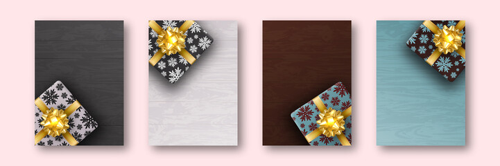 A set of four a4 format leaflets. Gift box is Packed in wrapping paper with painted snowflakes. Gold ribbon and bow in form of flower. Against the background of boards of different colors.