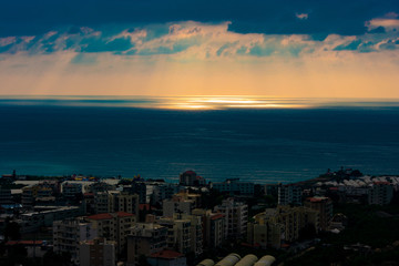 Fototapeta premium Sunset over the Mediterranean sea and the city of Byblos in Lebanon