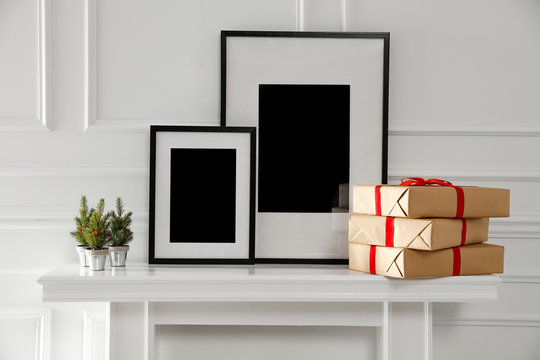 Christmas time in home and fireplace. Free space for your decoration and empty frames.Xmas decoration and white wall background. 