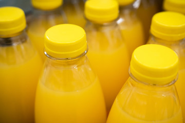Bottles of orange juice in a store.