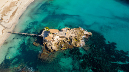 island with a wooden bridge in the Bay of Paguera, Majorca Spain