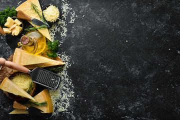 Piece of Parmesan cheese and cheese knife. On a stone background. Traditional Italian cheese. Top...