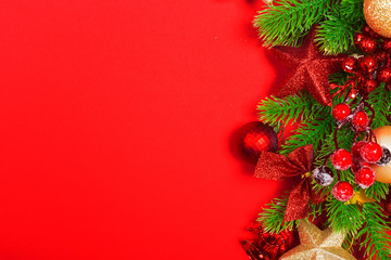 Christmas red background with herringbone and decor. Gold and red jewelry. Top view with space for copy.