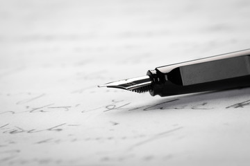 Fountain pen on an ancient handwritten letter. Old story. Retro style.
