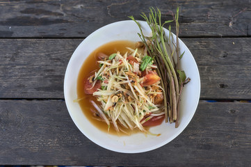 Thai som tam papaya salad on table.