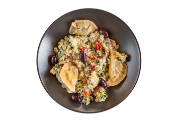 Healthy Quinoa Bulgur bowl with dumplings and black olives. Top view.