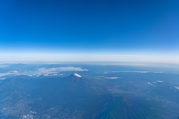 A birds eye view close-up the Mount Fuji ( Mt. Fuji ) and blue sky. Scenery landscapes of the Fuji-Hakone-Izu National Park. Shizuoka Prefecture, Japan