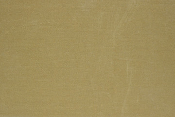 Textile surface olive green. Book cover. View from above. Not new, with scuffs. Dark background or wallpaper. Reduced contrast. Macro