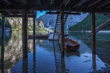 Rowing boats moored on the jetty in an idyllic setting, Braies Lake, South Tyrol, Italy. Concept: relaxation in nature, famous natural places, film sets
