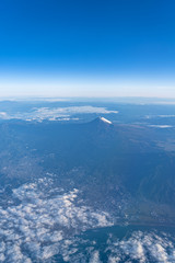 Fototapeta na wymiar A birds eye view close-up the Mount Fuji ( Mt. Fuji ) and blue sky. Scenery landscapes of the Fuji-Hakone-Izu National Park. Shizuoka Prefecture, Japan