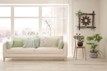 Stylish room in white color with sofa and winter landscape in window. Scandinavian interior design. 3D illustration
