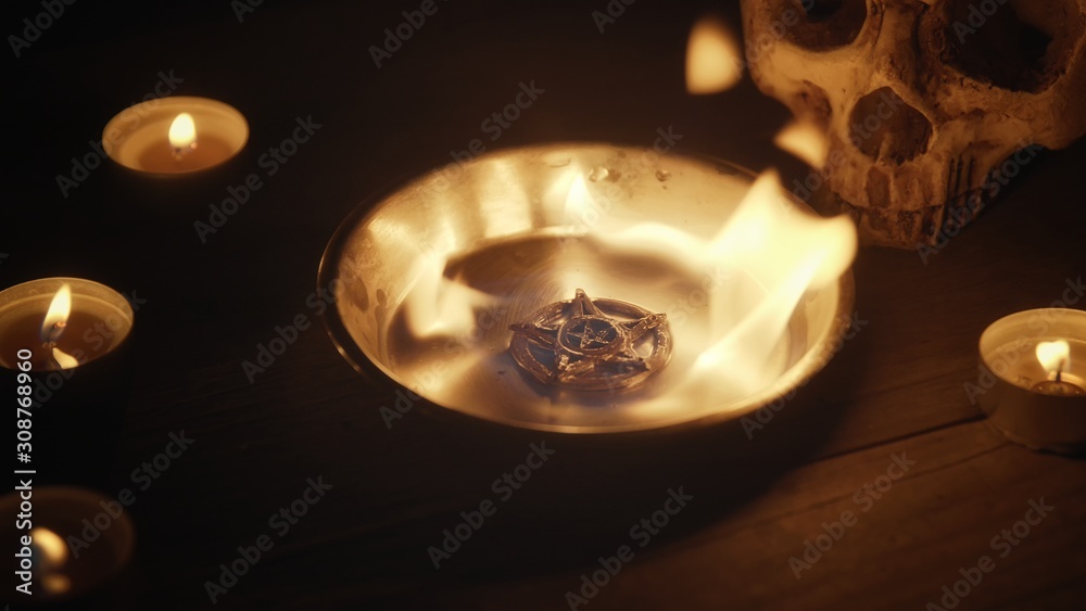 Wall mural Burning pentacle on altar closeup photo