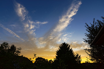Colorful sunset against silhouettes in the suburbs