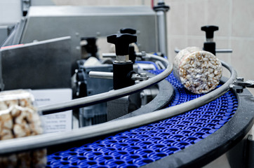 conveyor automatic tape for the production of useful whole-grain extruder crispbread. packing organic multi-barley briquetted crispbread on factory